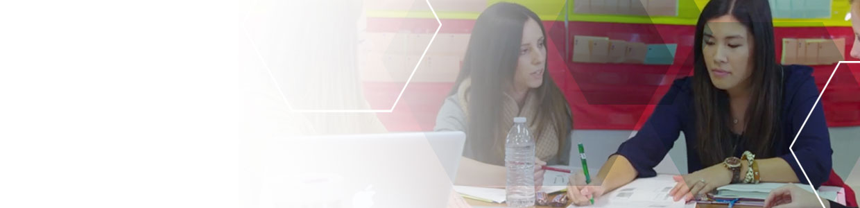 Two educators sitting together and working on a handout
